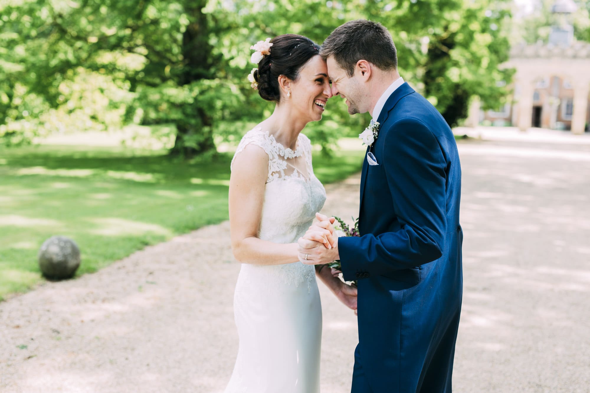 bride and groom at nether winchendon house laughing