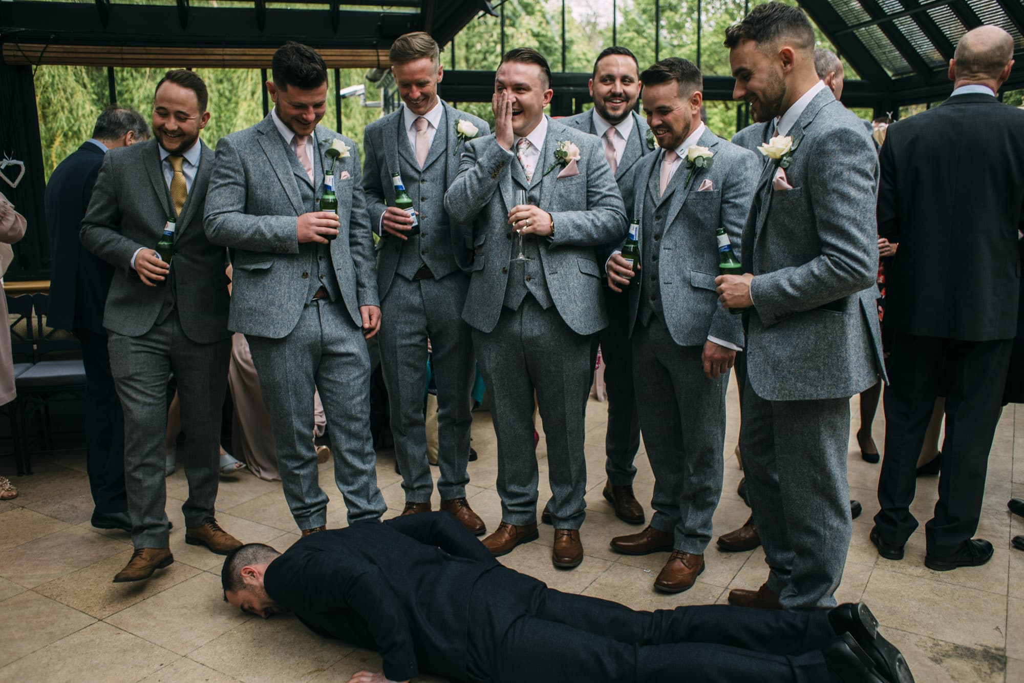 groom laughs with ushers