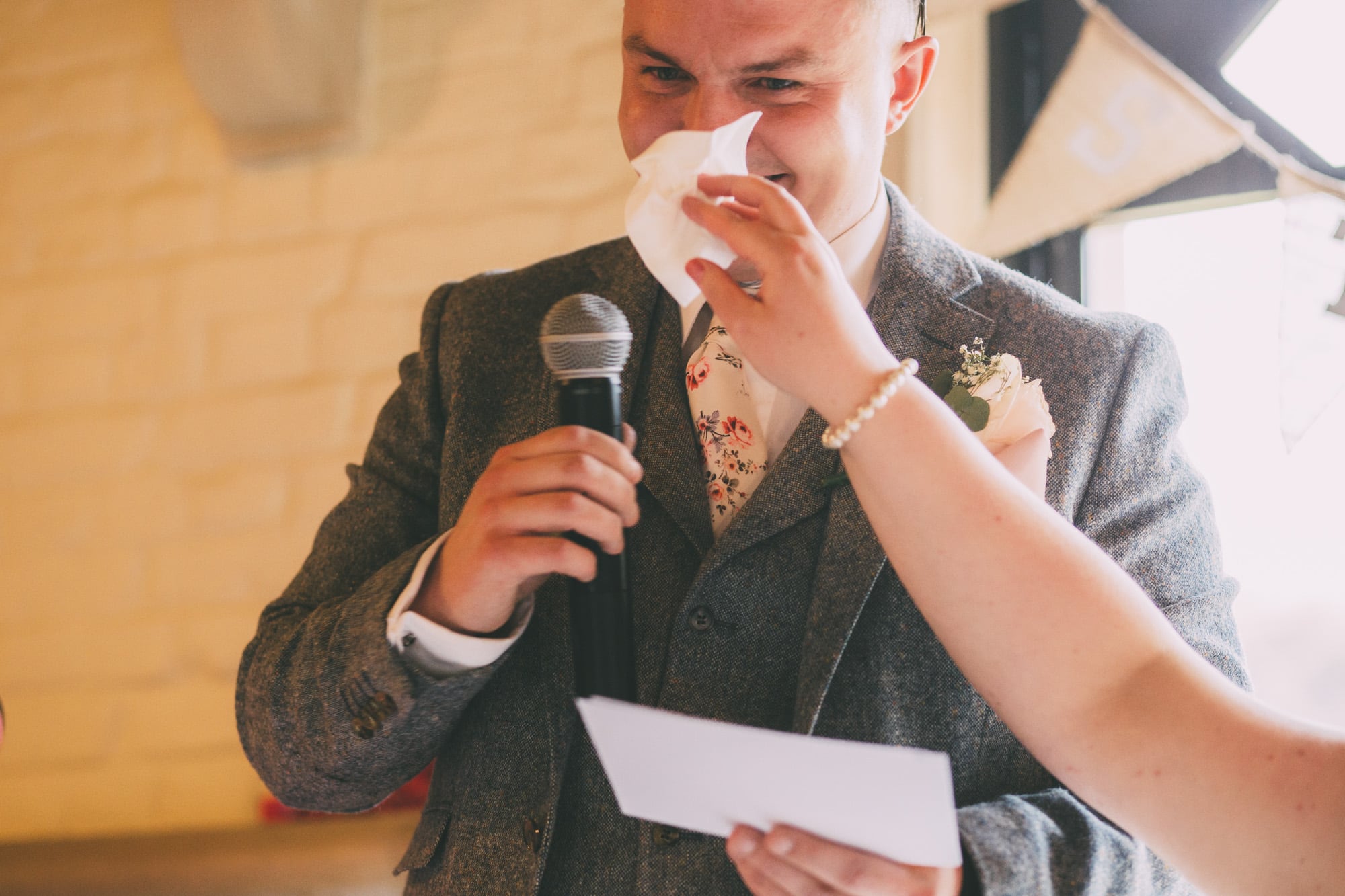 groom wipes tears and laughs