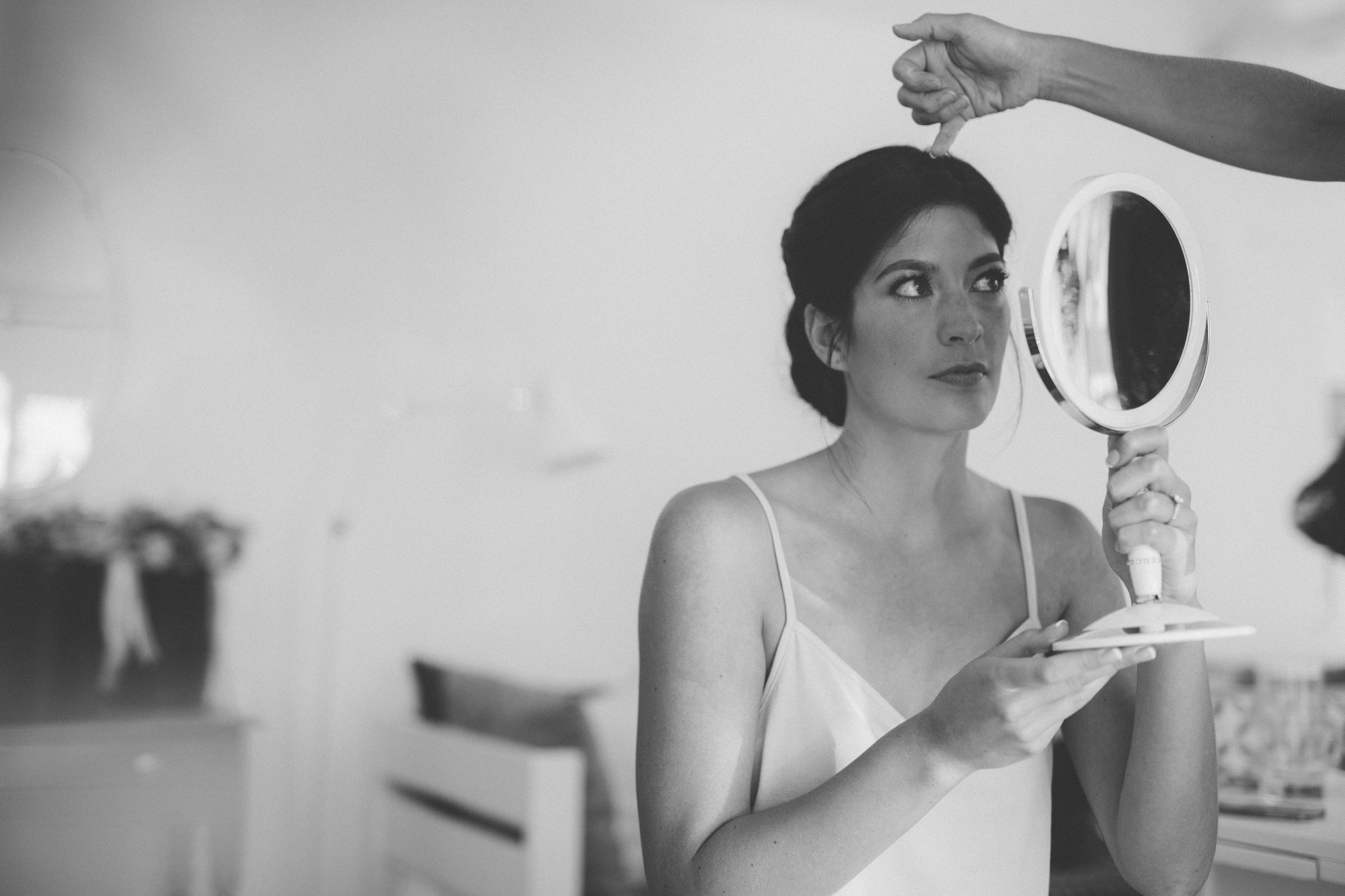 bride inspects makeup