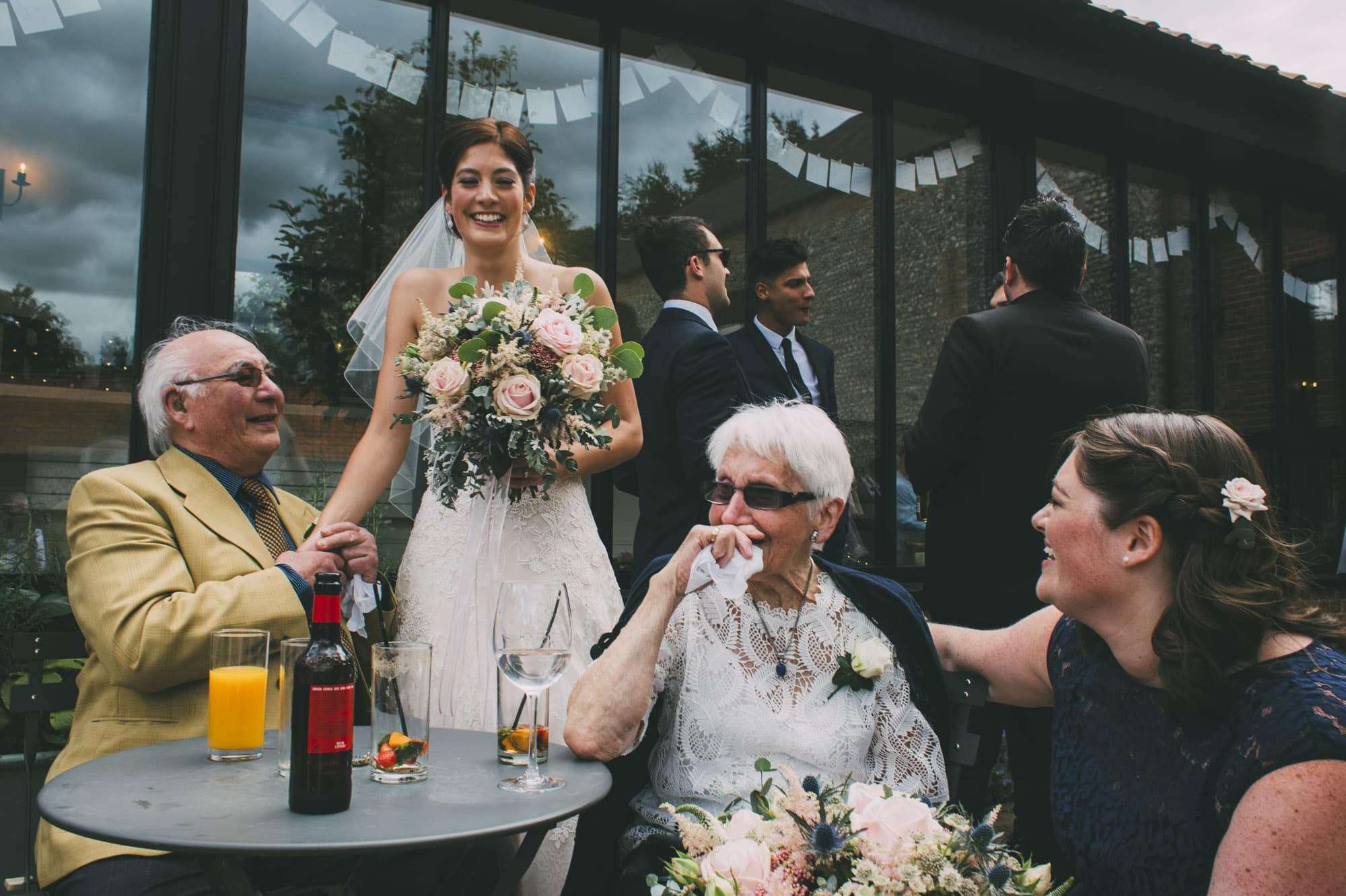 bride laughing with grandparents