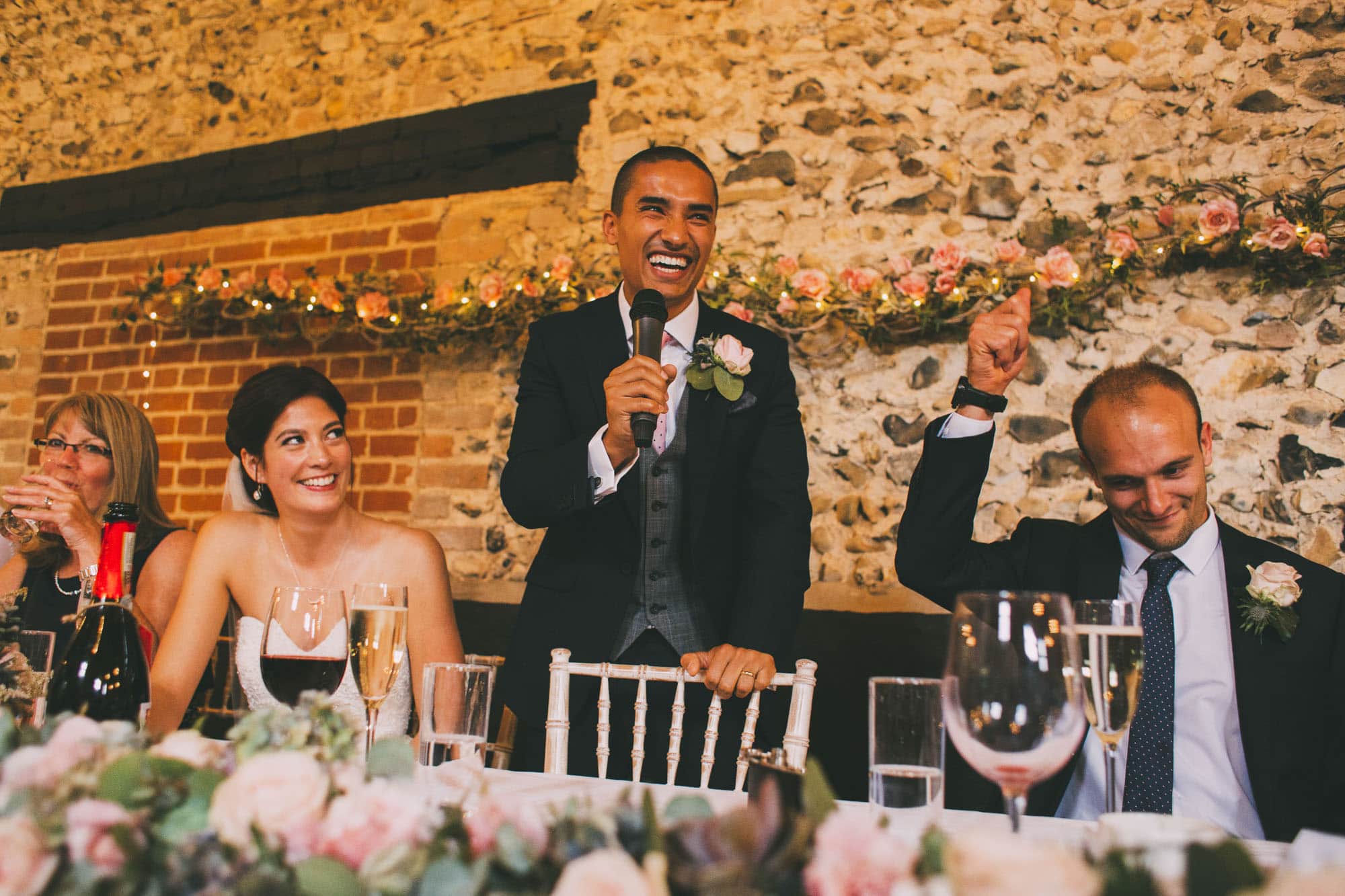 bride laughing during grooms speech