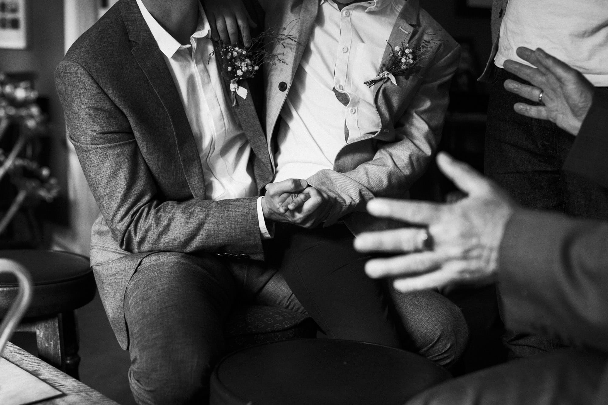 groom and son hold hands