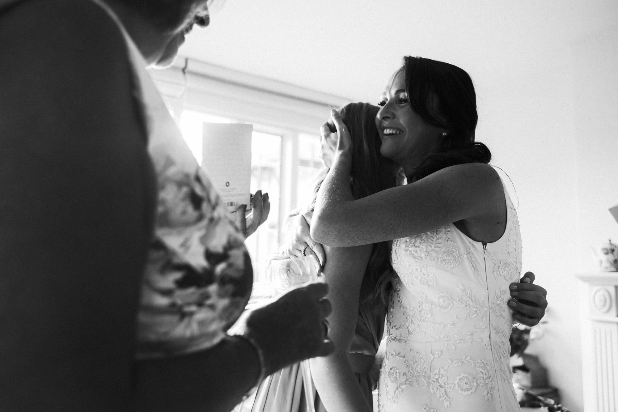 bride hugs daughter and smiles
