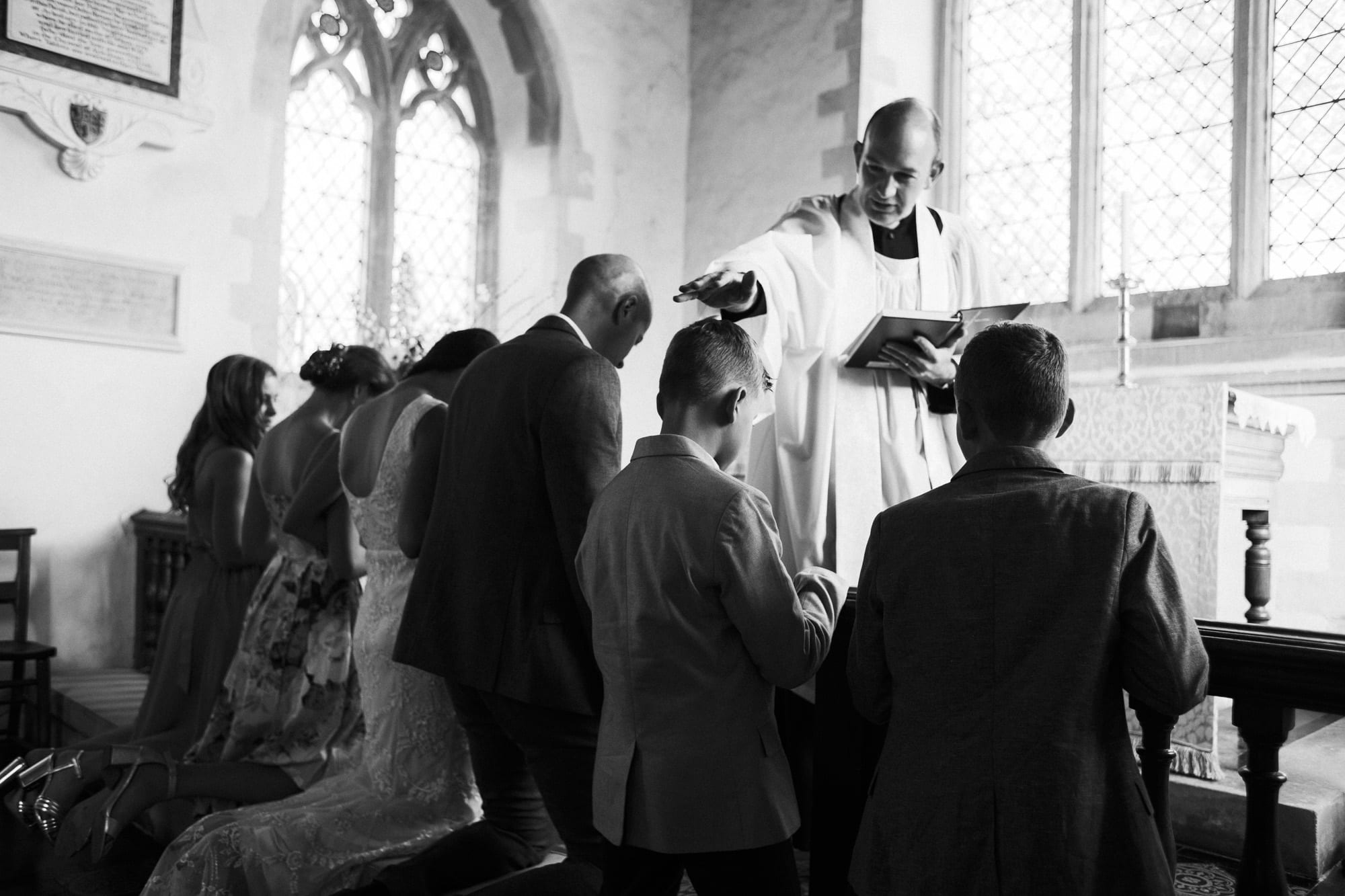 vicar gives blessing to the family