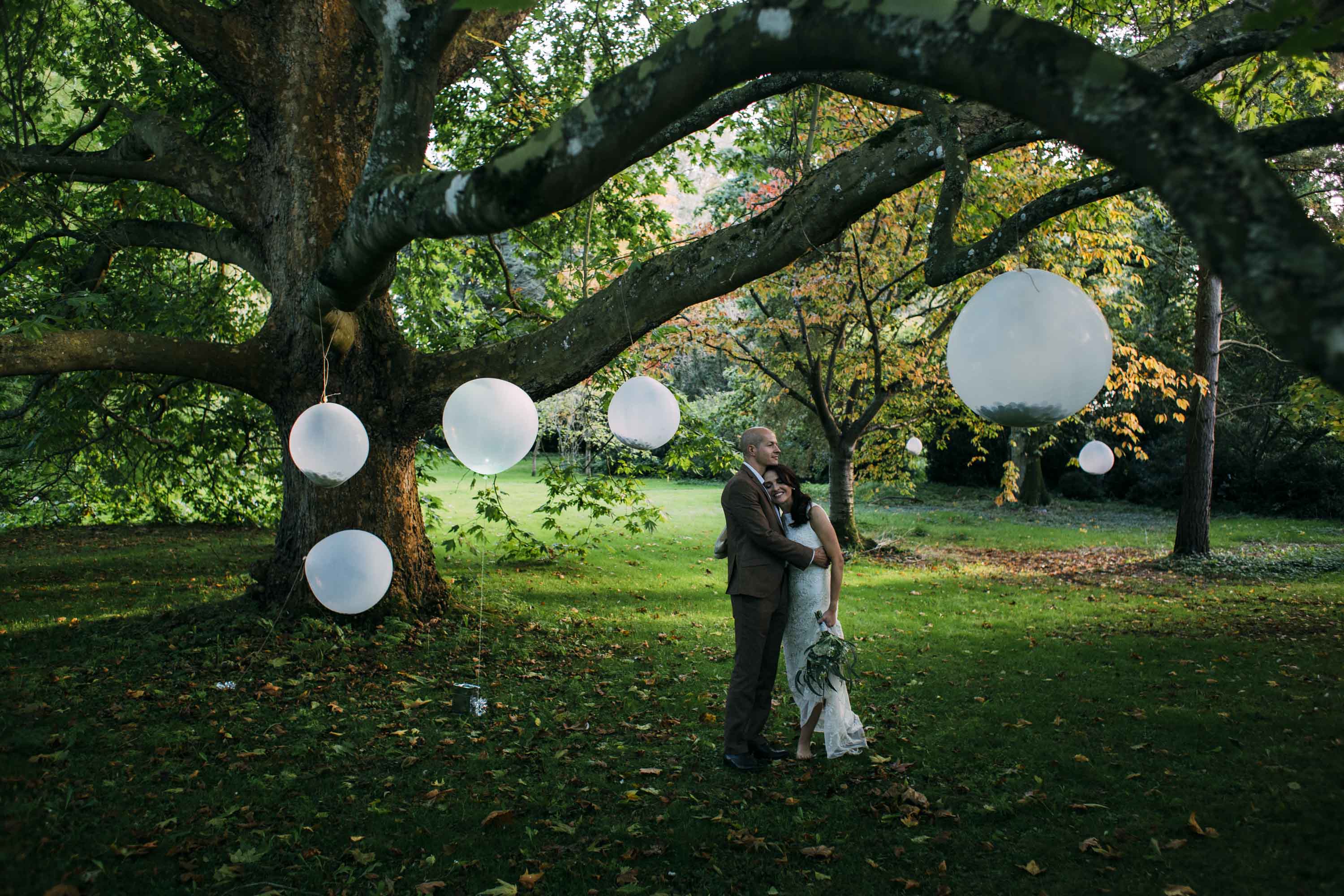 bride and groom under tree at nether winchendon house