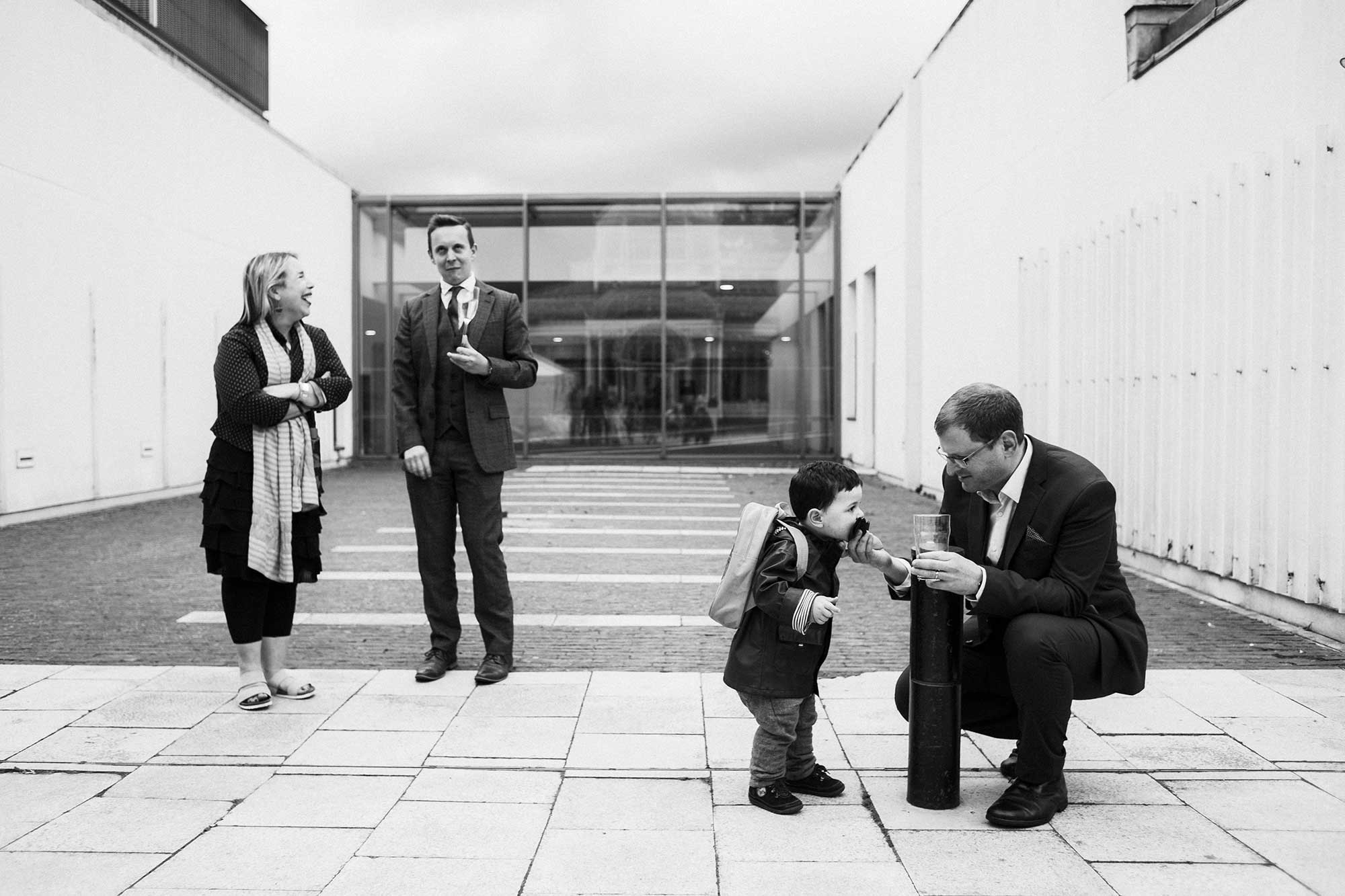 black and white wedding photography guests laughing and eating