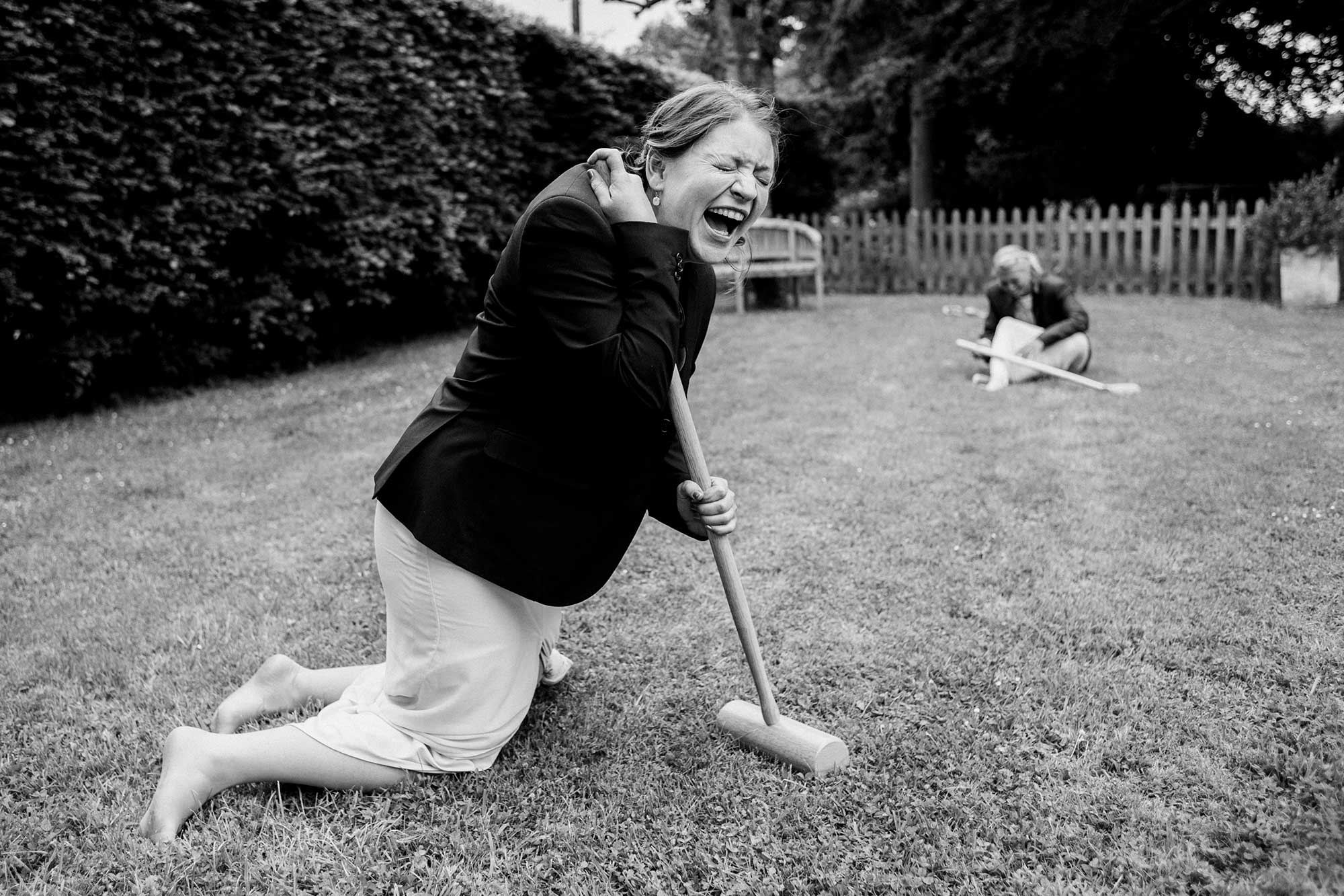 wedding guests laughing playing croquet