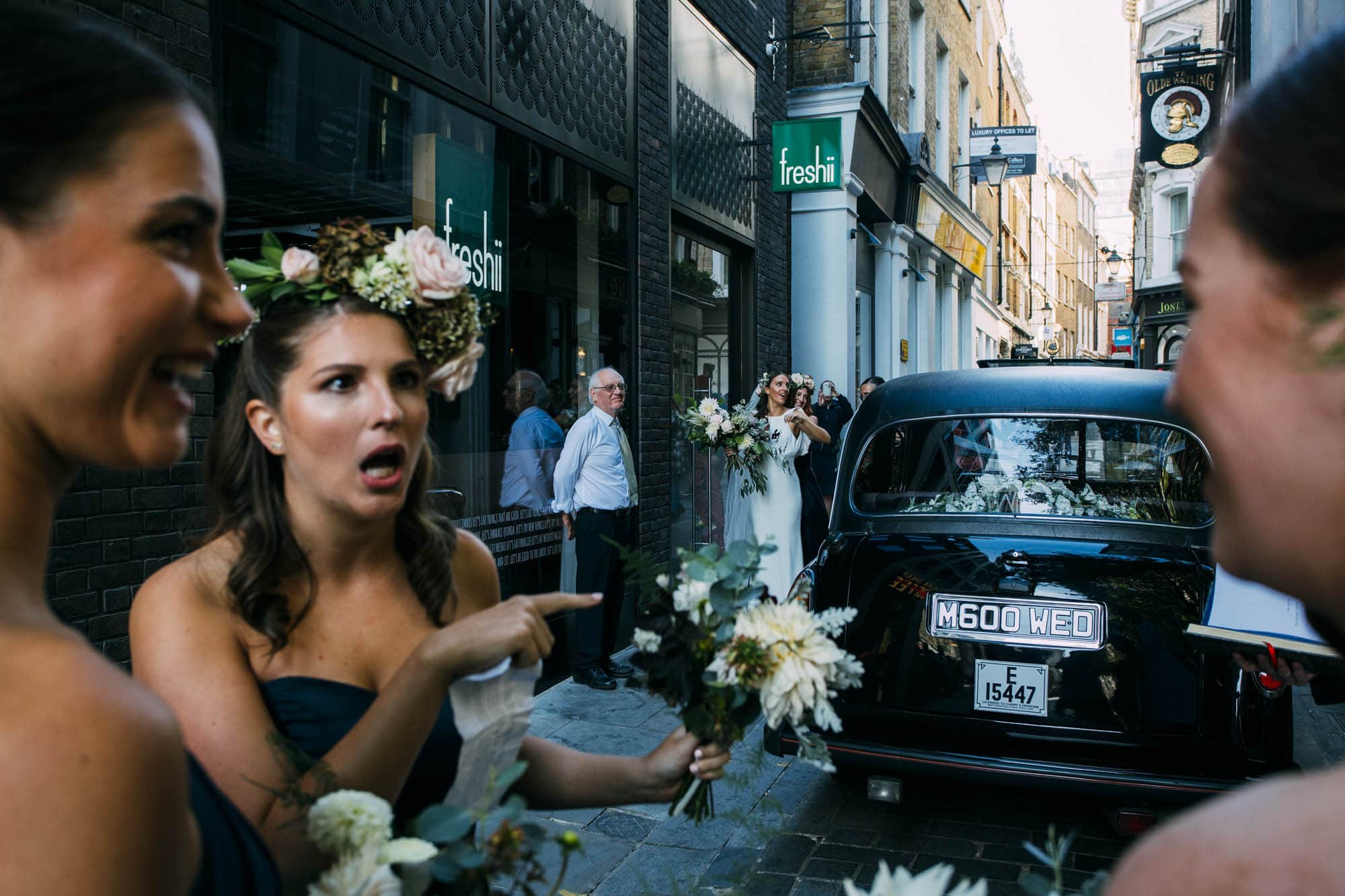 bride arrives in black london taxi