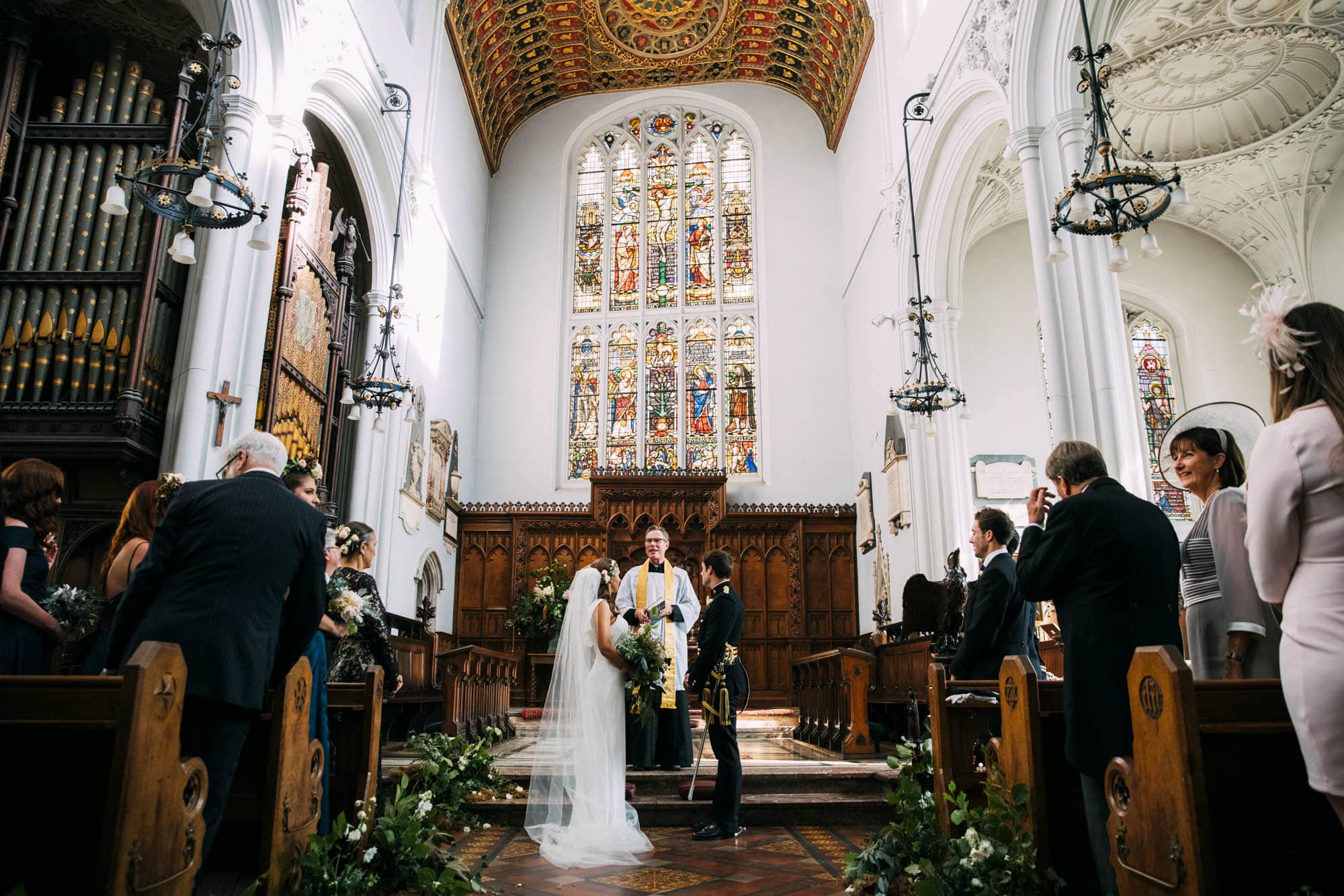 wide angle photograph of bride and groom in church