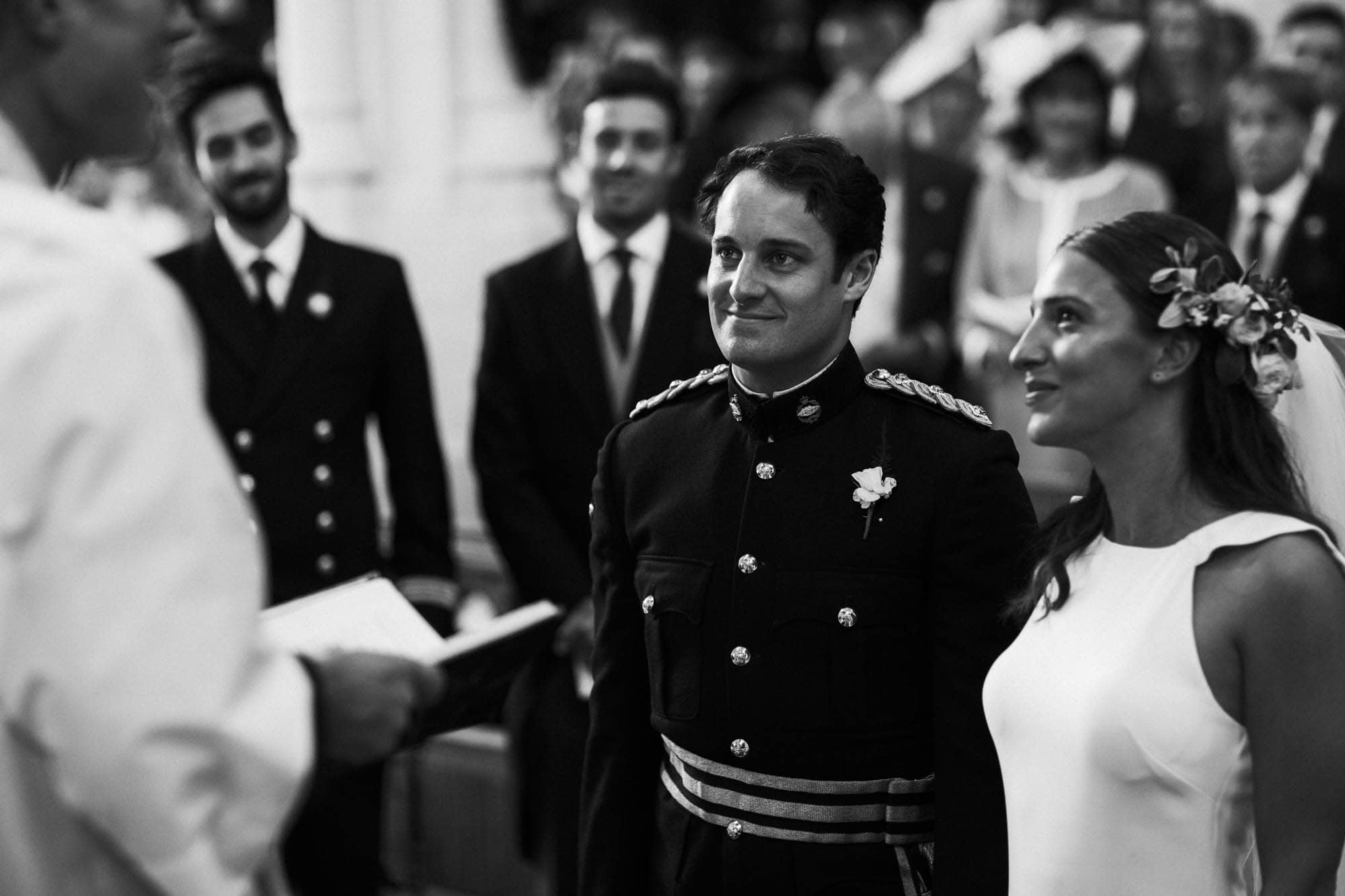 bride and groom smiling in black and white photograph