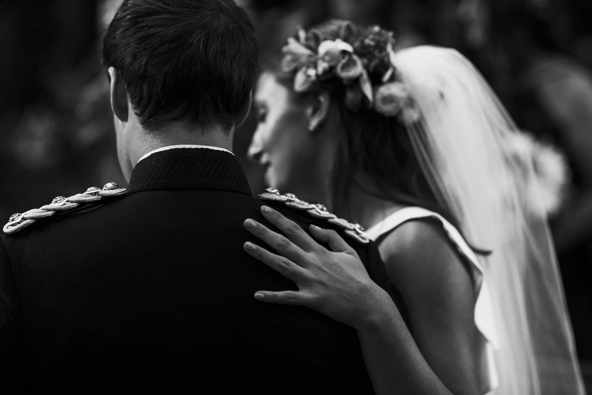 affectionate bride puts hand on grooms back