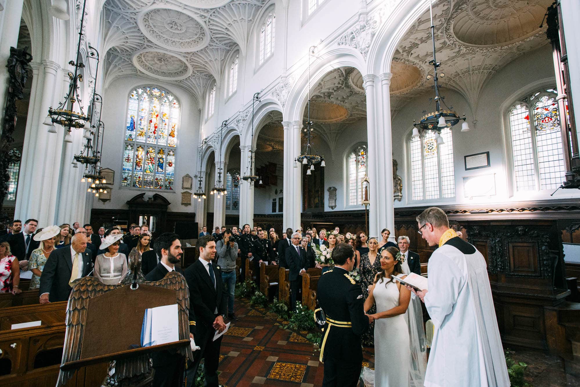 wide angle photograph of bride and groom during wedding service