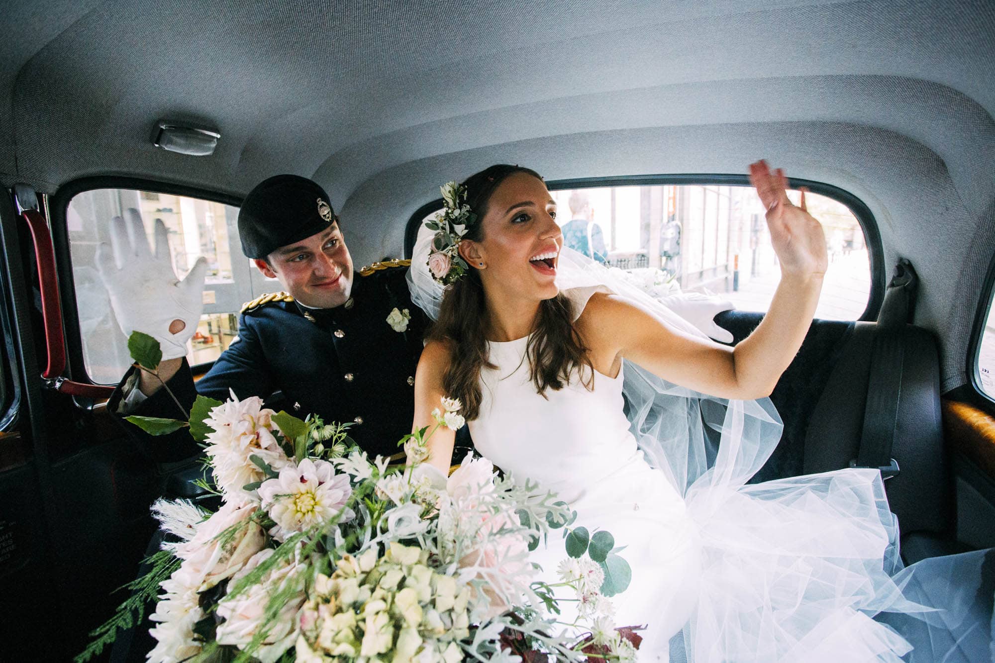 bride and groom in black london cab