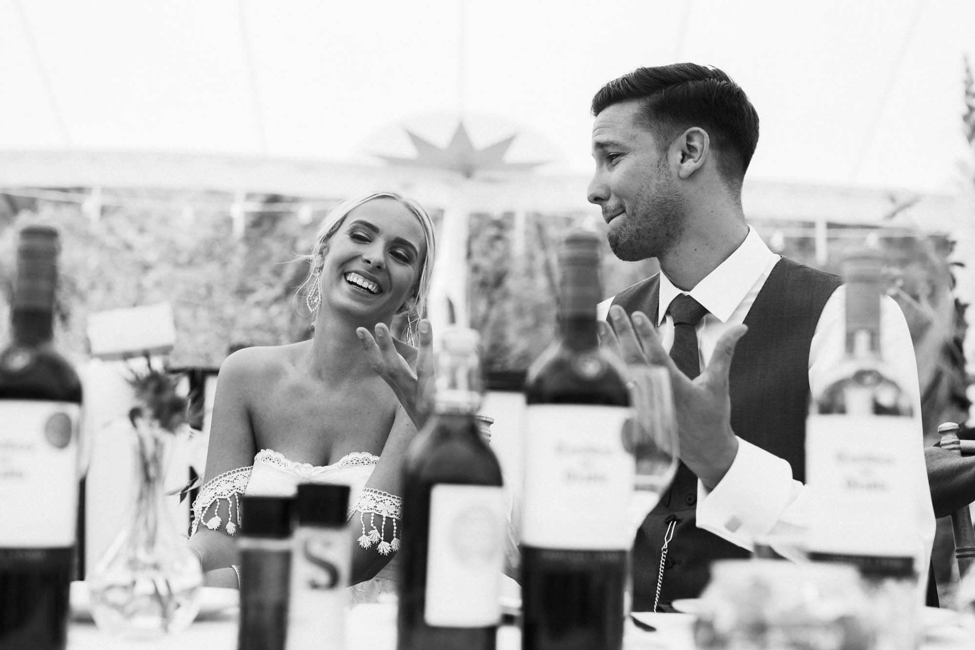 bride and groom laugh during speeches