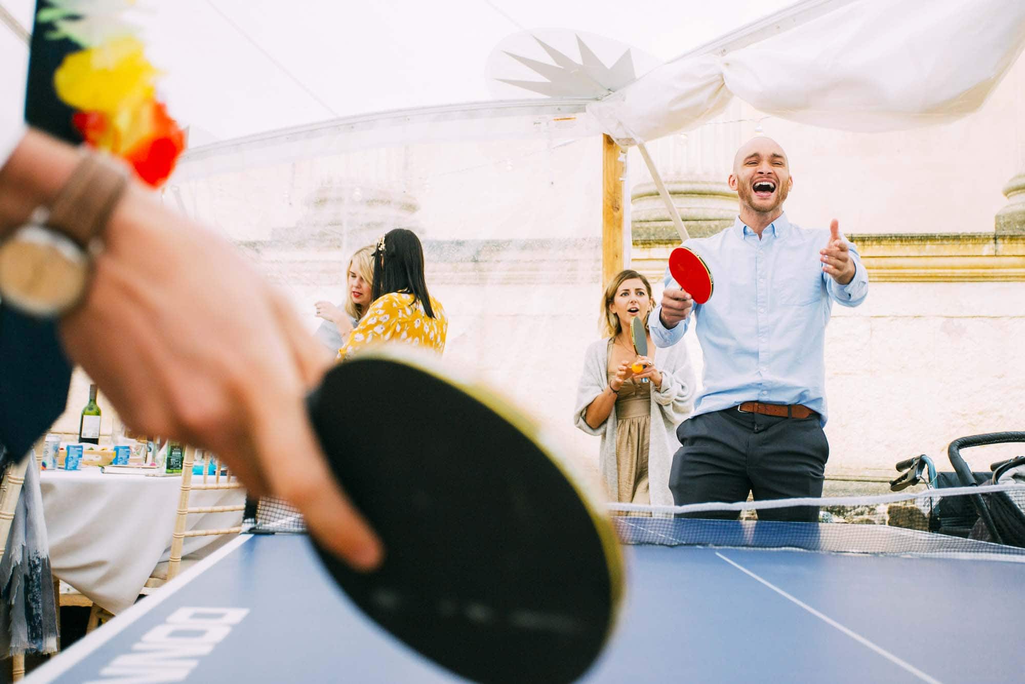 wedding guests play ping pong