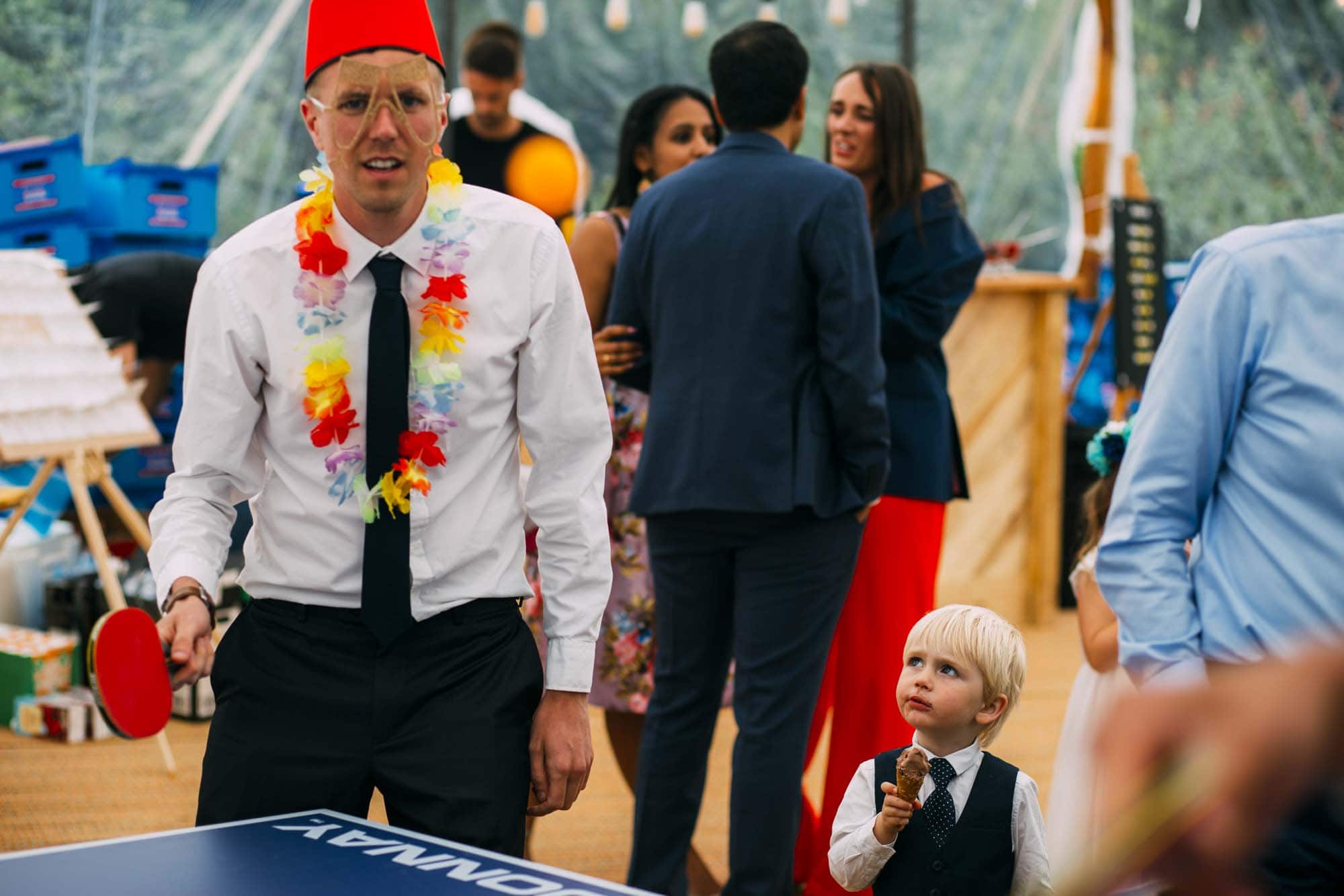 child stares at man in fancy dress